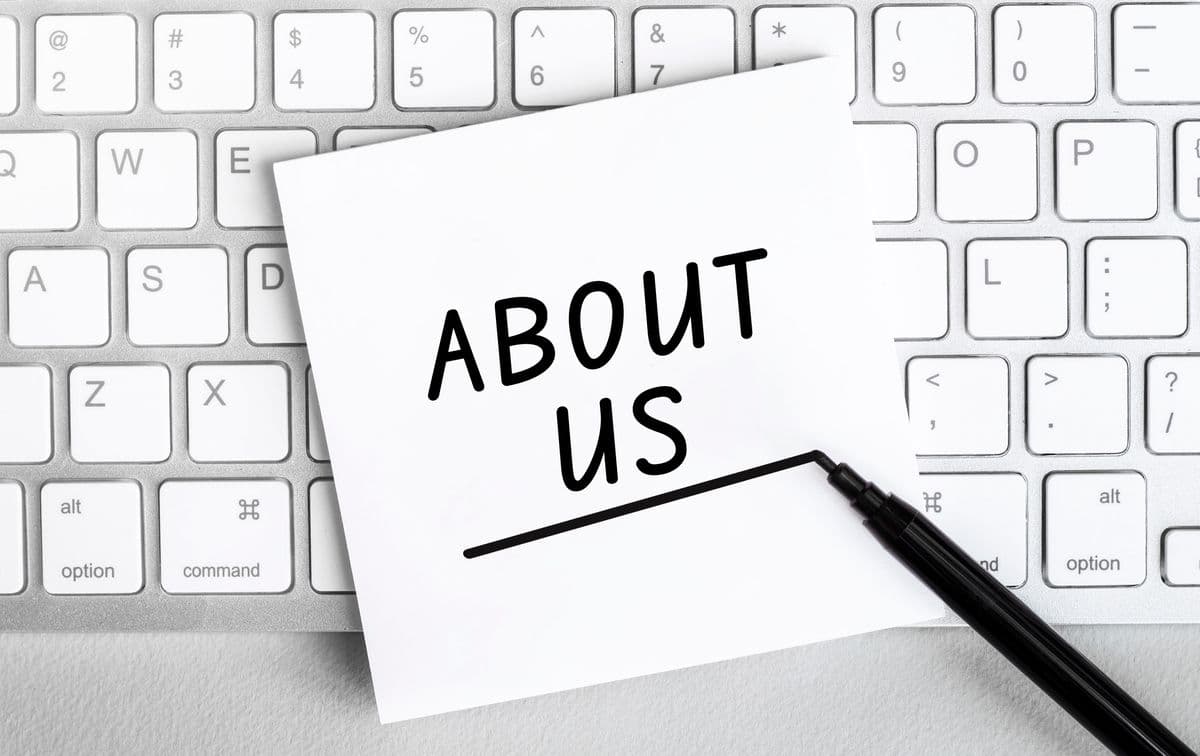 An About Us note on a keyboard